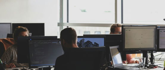 people sitting on chair in front of computer monitor